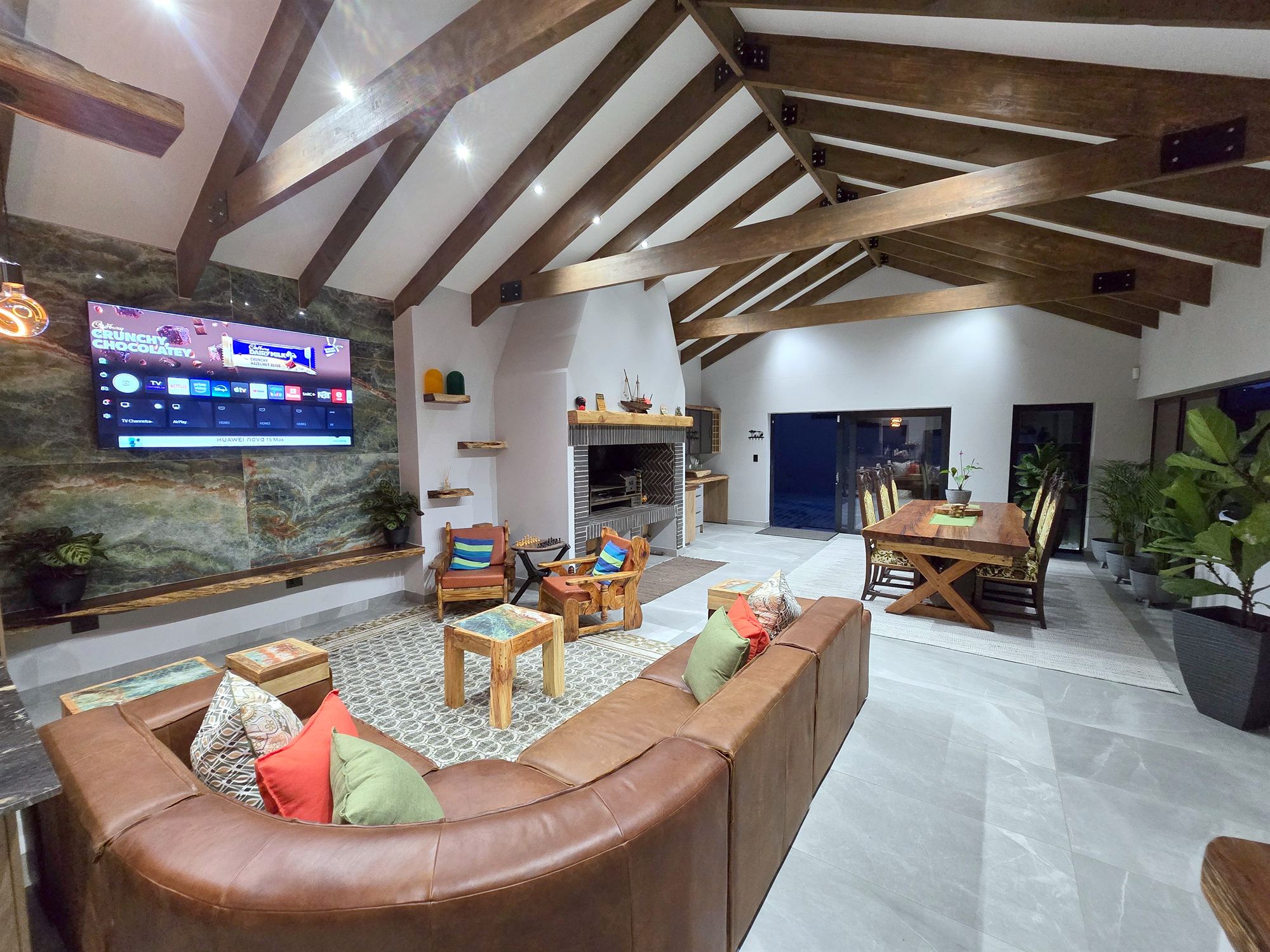 The Wild Hive lounge with timber beams and a green feature wall